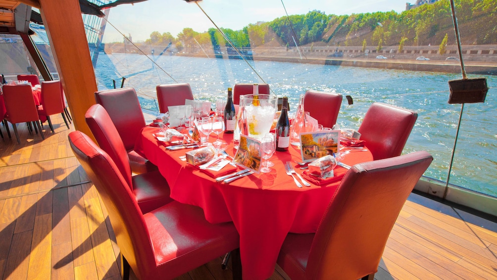 Red table and chairs on Lunch cruise in Paris