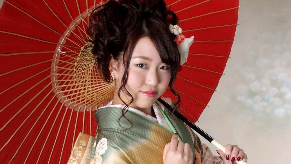 Show item 4 of 5. Woman posing with kimono and parasol in a studio in Nagoya