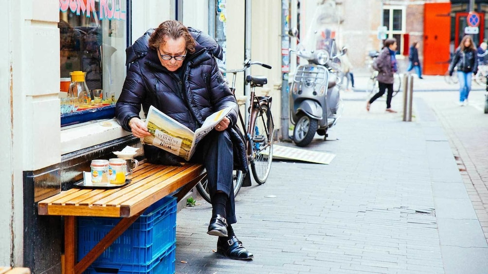 Charger l’élément 2 sur 10. man reading outside a cafe in Amsterdam