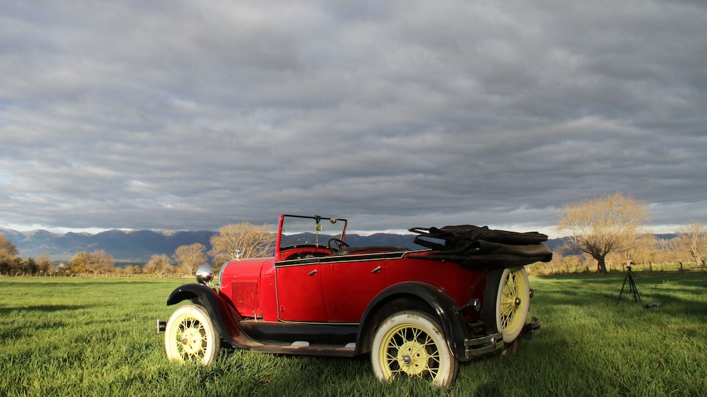 Show item 2 of 5. antique red car in field