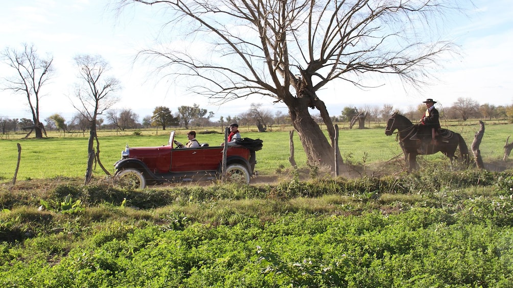 Show item 2 of 5. antique car in front of a horse riding gentleman in Argentina