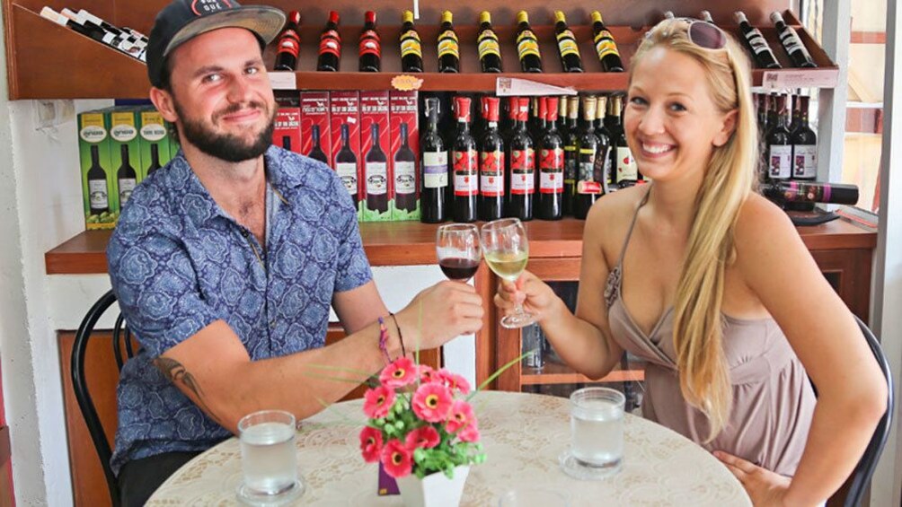 Show item 1 of 6. Couple on drink tasting tour