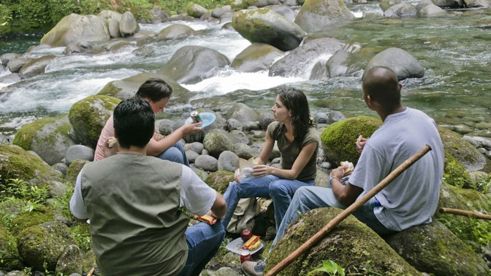 group having lunch next to the creek in Costa Rica