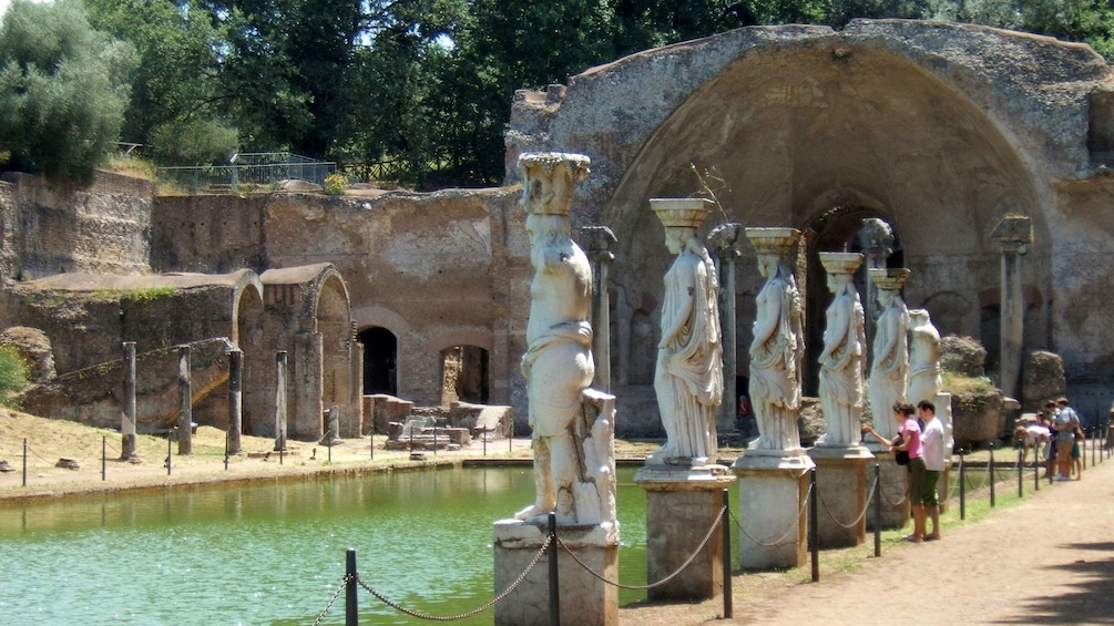 Row of statues line a pool in the ruins of Trivoli