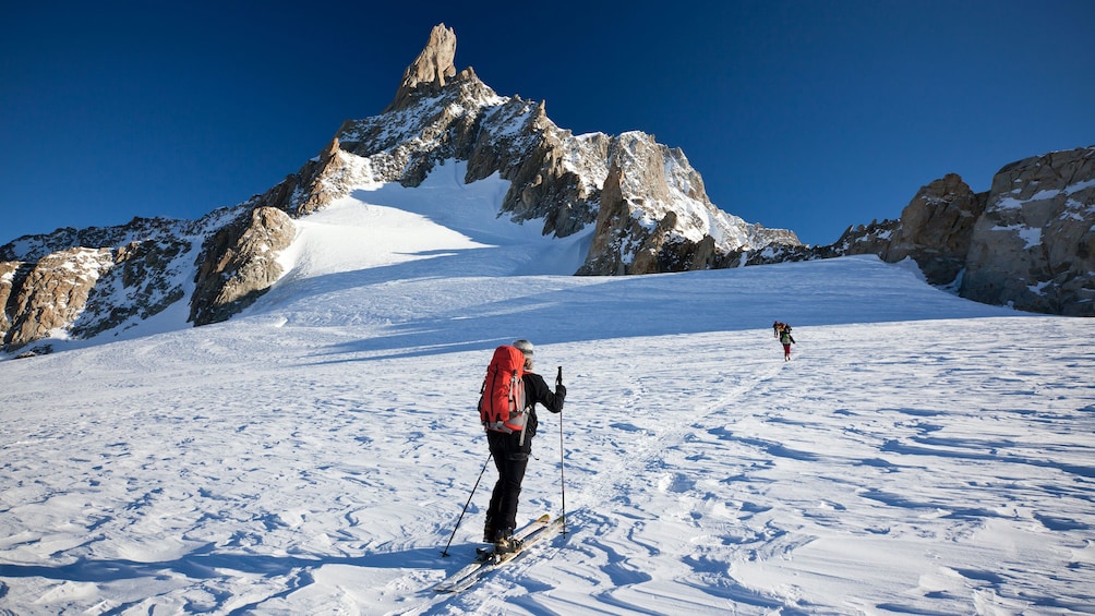 Skiers making way up mountain in Chamonix