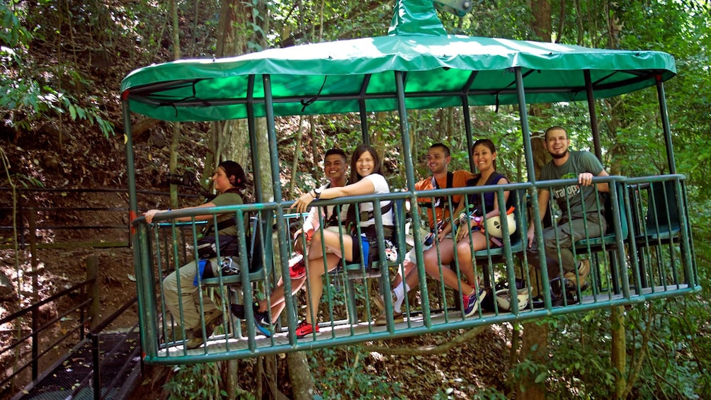 group taking a caged tram through the forest in Costa Rica