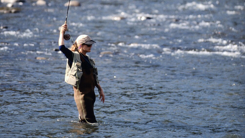 Fly fishing woman in a river in Fairbanks