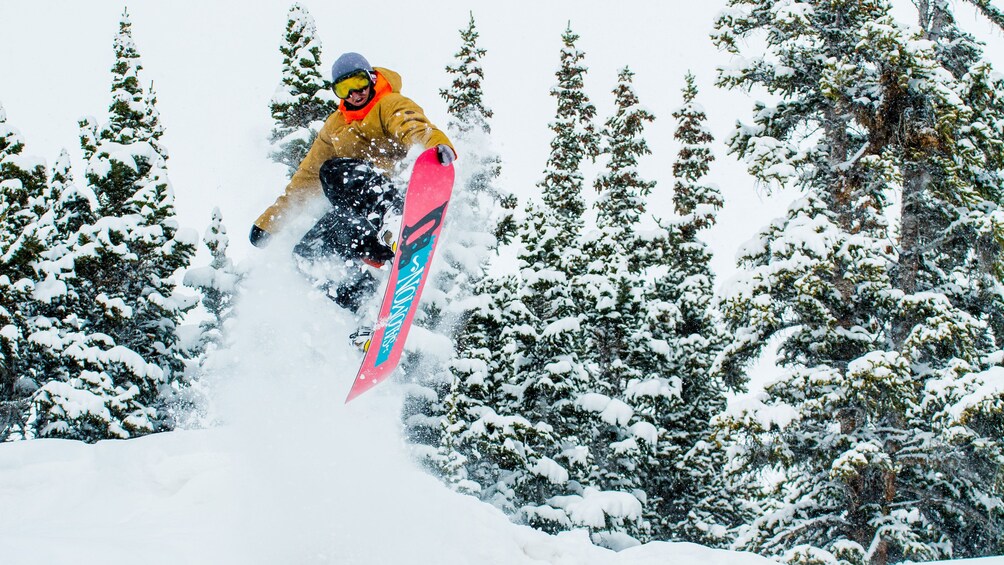 Snowboarding in the air after a jump on a mountain