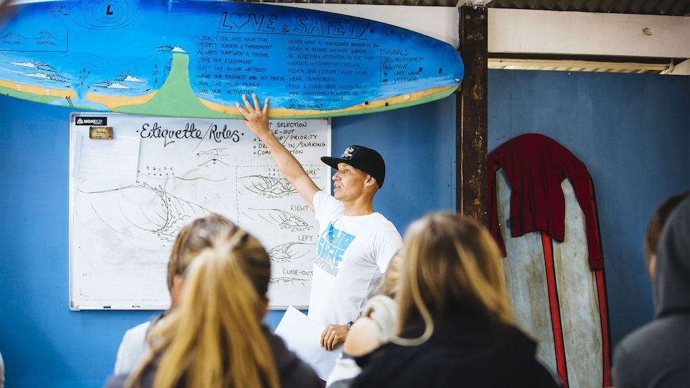 Show item 3 of 4. Group receiving instruction on the Byron Bay Surf Lesson in Australia