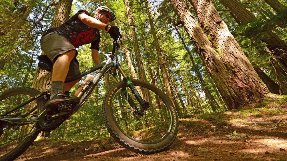 man riding up a hilly trail in Canada