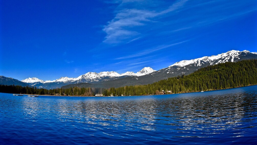 Beautiful view of the water and surrounding mountains and trees in Whistler 