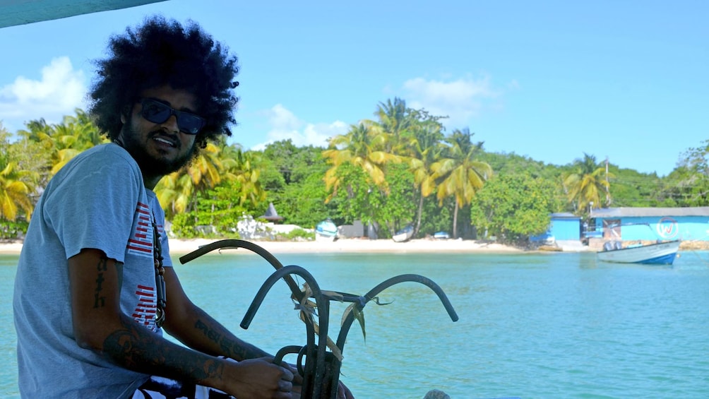 man sitting on a small boat in Trinidad and Tobago