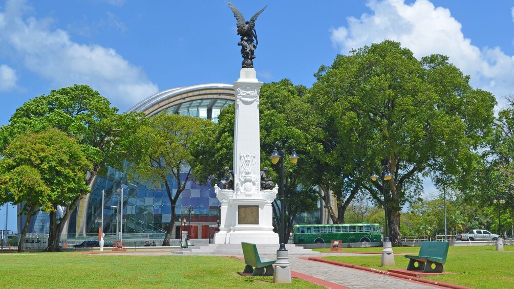 monument in front of a glass structure in Trinidad and Tobago