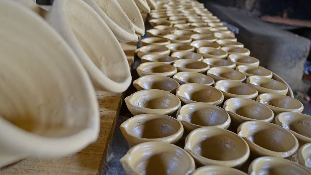 Rows of clay dishes ready to be baked in Trinidad and Tobago