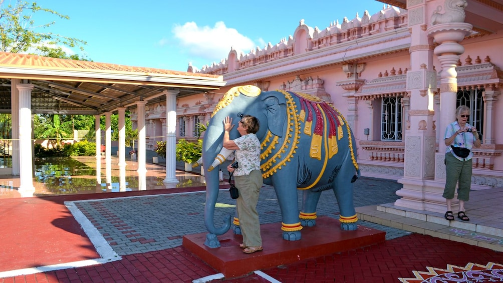 woman engaging an elephant sculpture in Trinidad and Tobago