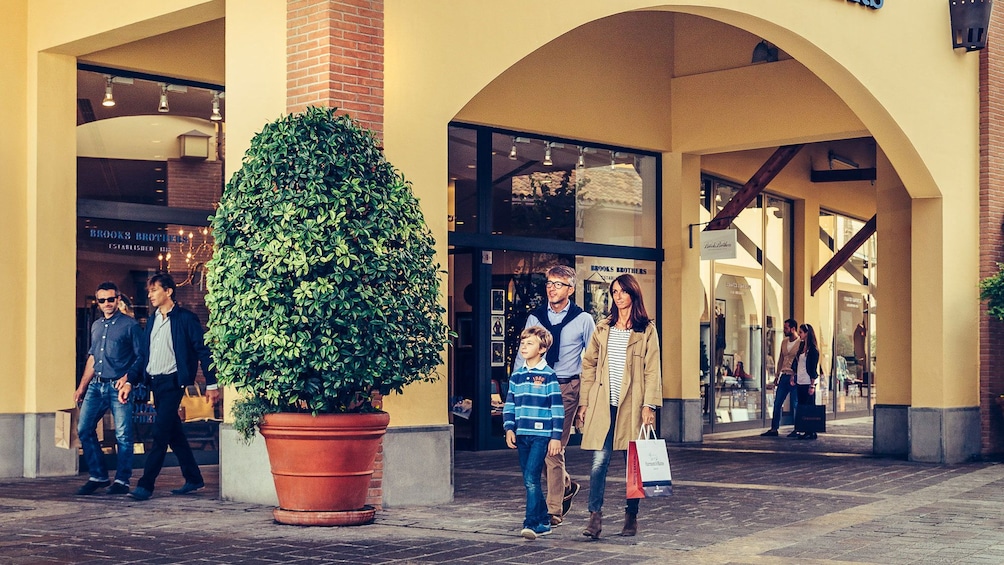 Show item 3 of 6. Humans shopping in a Italian shopping complex