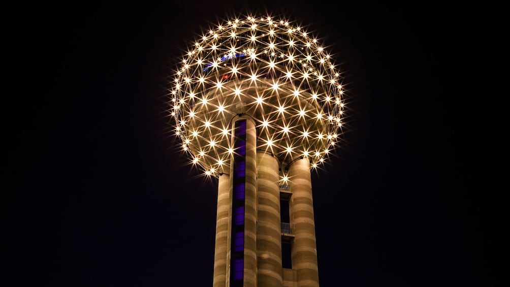 Show item 1 of 6. circular structure lit at the top of a tower in Dallas