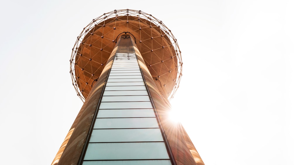 circular structure lit at the top of a tower in Dallas