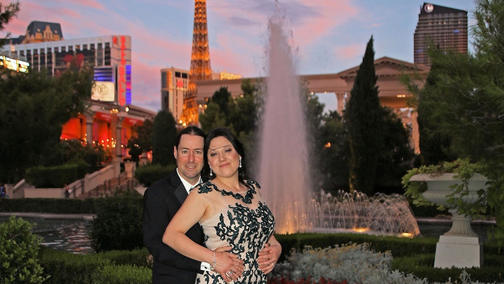 Show item 2 of 5. couple posing at fountain in las vegas