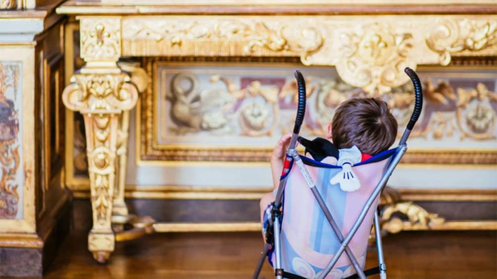 Child in a stroller at the Louvre Museum in Paris