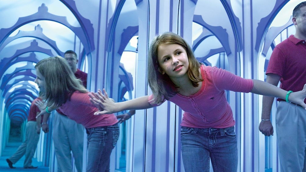 Girl at the maze of mirrors at the Hollywood Wax Museum in Branson, MO