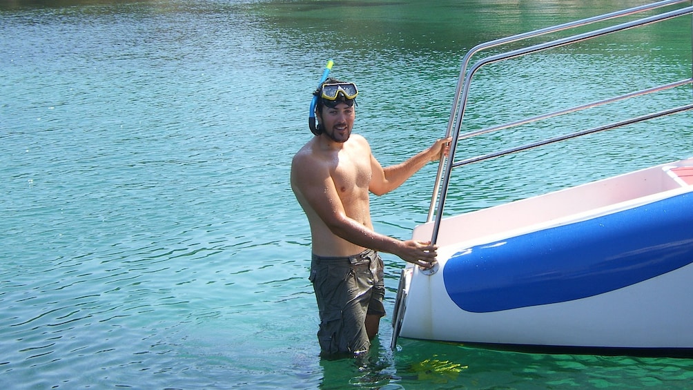 Man climbs back into a boat.