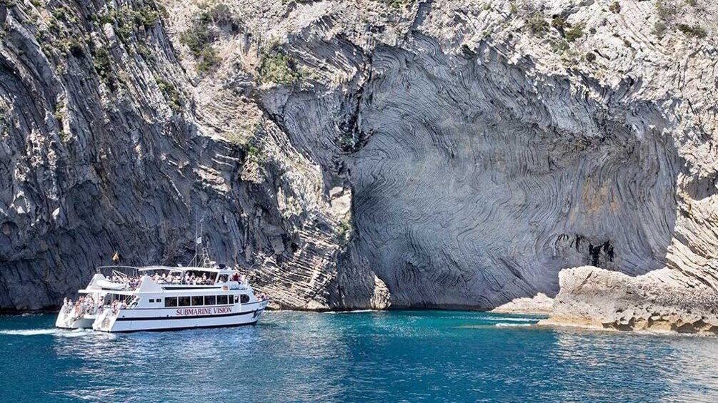 Cruise boat next to Coastline of Majorca