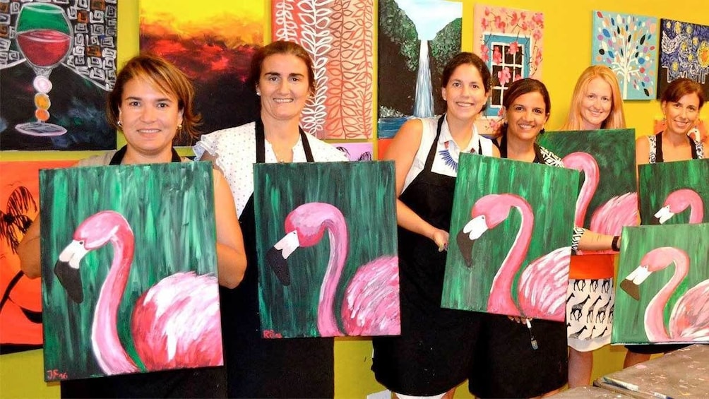 Show item 3 of 5. Group with flamingo paintings from the Paint and Sip Party in Nassau