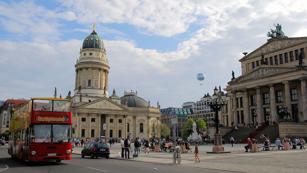 Show item 3 of 9. Hop-on hop-off bus driving past historic buildings in Berlin