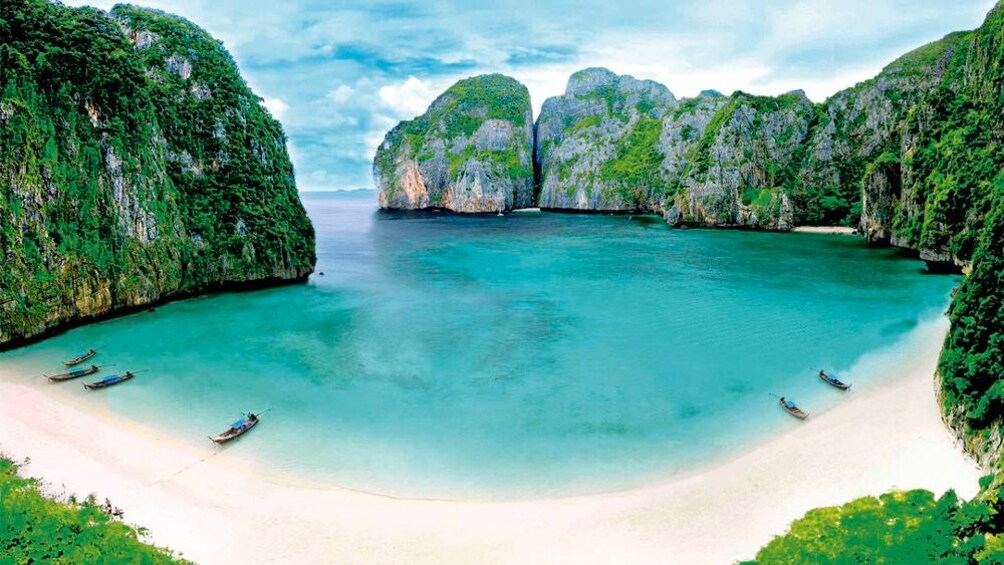 a circular beach formed by rocky mountains in Thailand