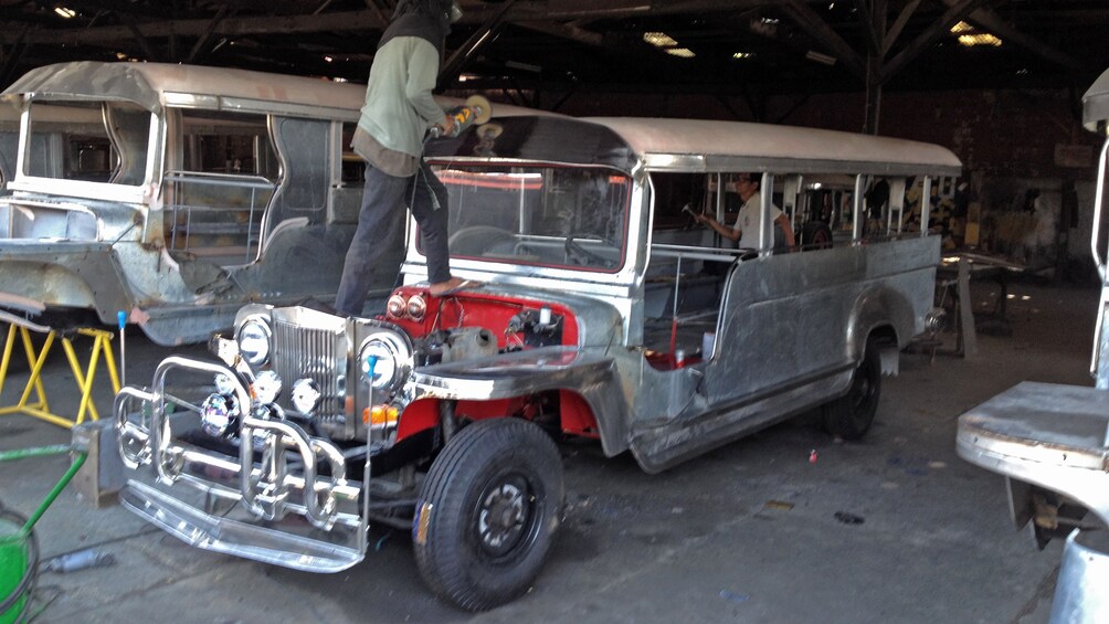 Show item 5 of 5. people working on bus