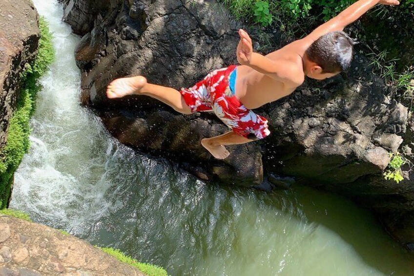 A boy jumps into one of the pondes