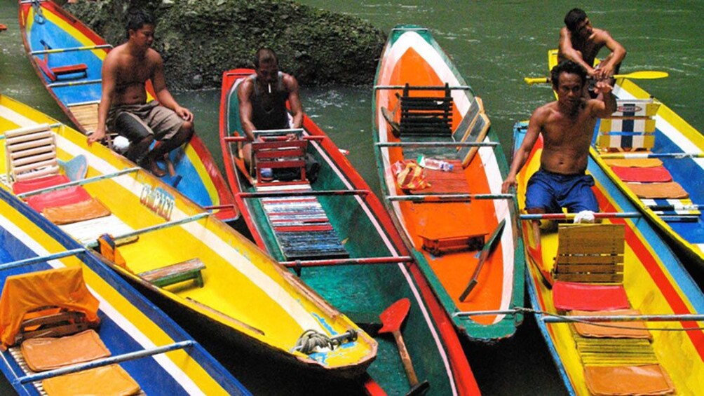 Men in colorful canoes