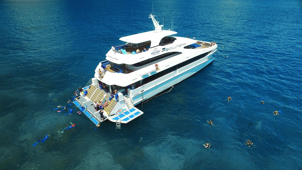 Aerial view of yacht and snorkelers
