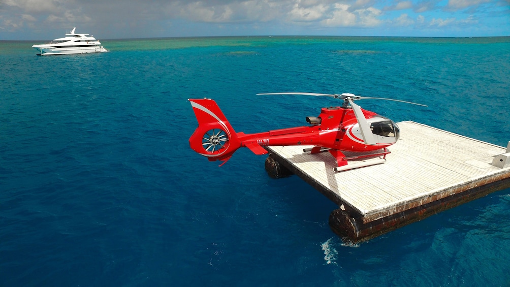 Helicopter on a dock in view of yacht