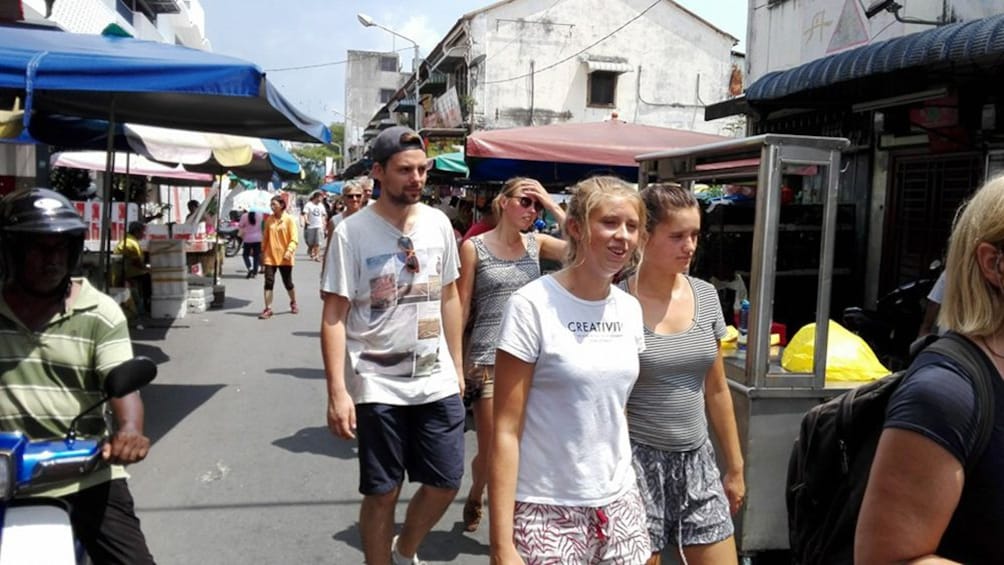Tourists walk the streets of Panang