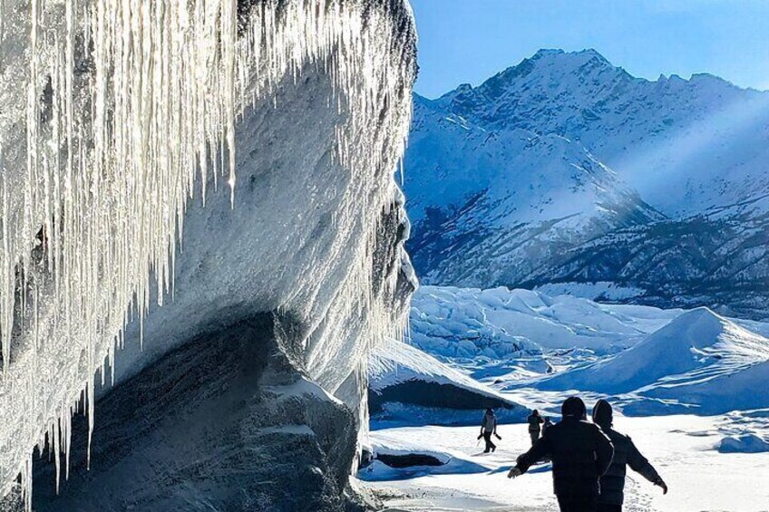 Walking by a huge ice wall and icicles