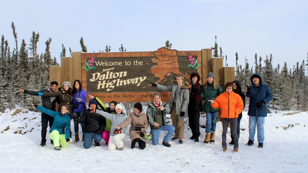 Group next to the James Dalton highway sign in Coldfoot 