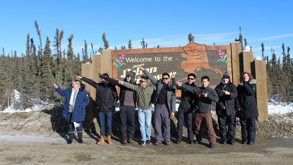 Group at the James Dalton Highway sign in Alaska