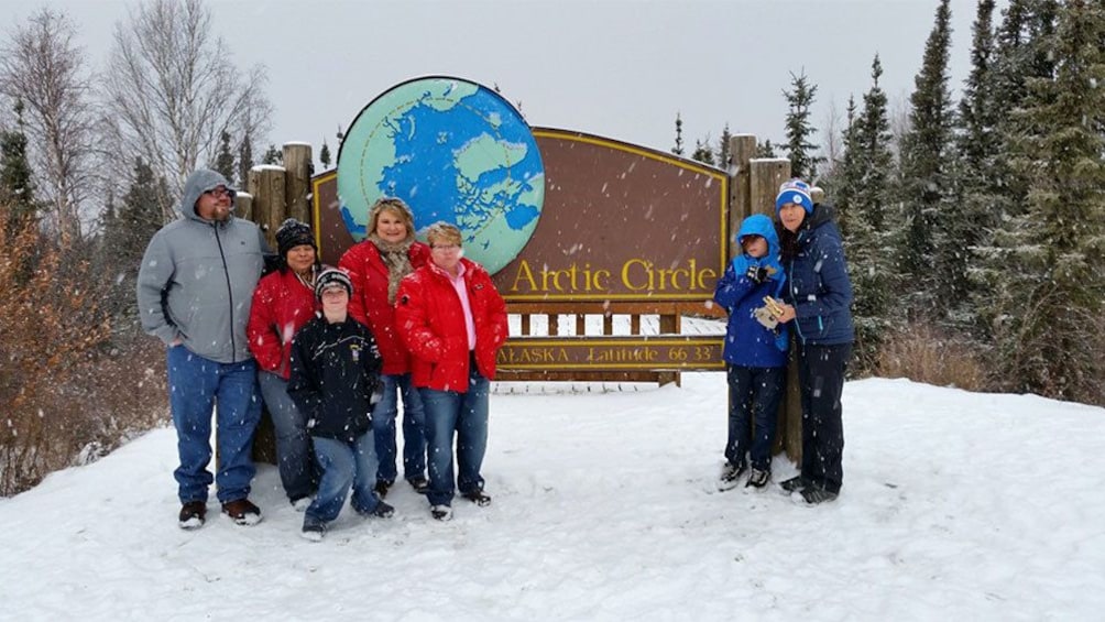 Group taking picture at the Arctic Circle SIgn