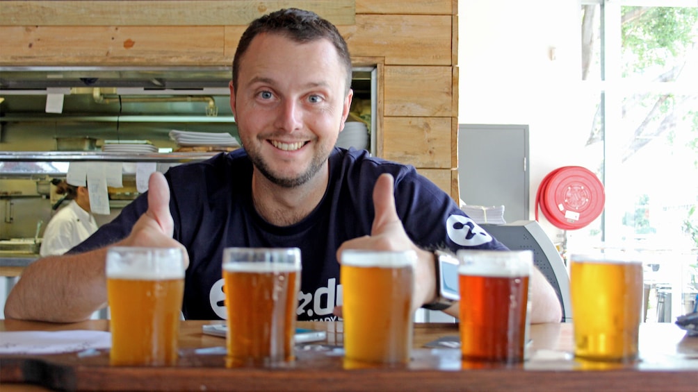 Man sitting next to five beers on the Craft Beer Tour in Sydney 
