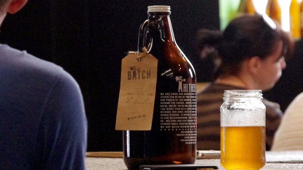 Growler and glass of beer at a bar in Sydney