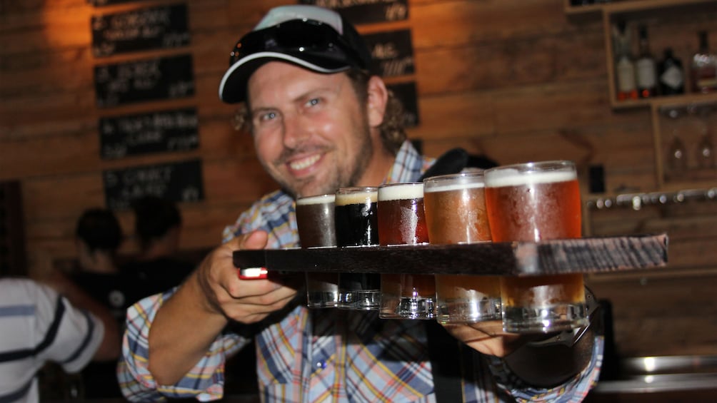 Man with flight of beer at a bar in Sydney