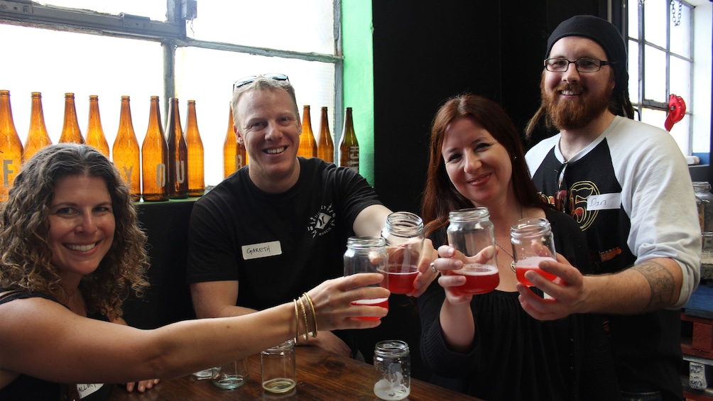 Group toasting with glasses of beer in Sydney