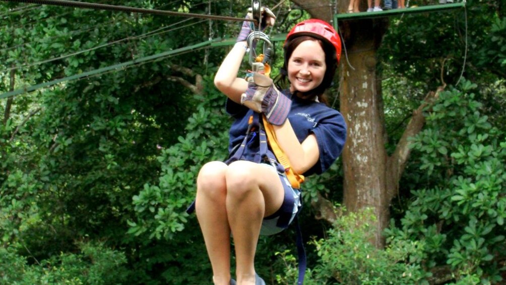 Close up of a young lady ziplining in Costa Rica 