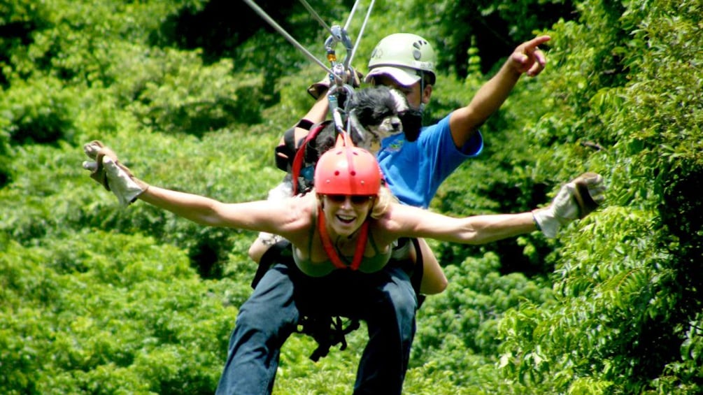Man, woman and dog zip line in Costa Rica