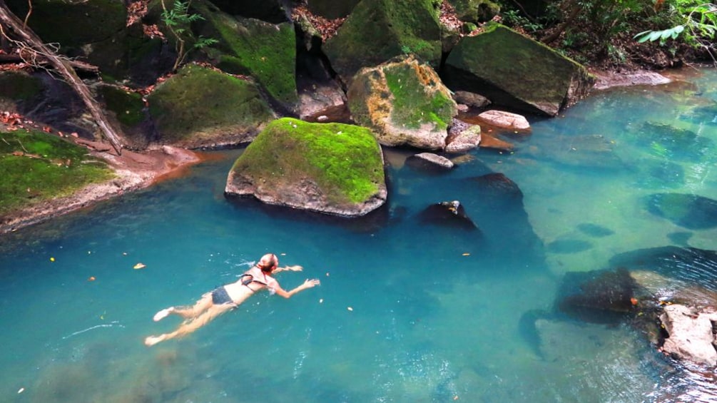 Woman swims in a river in Costa Rica