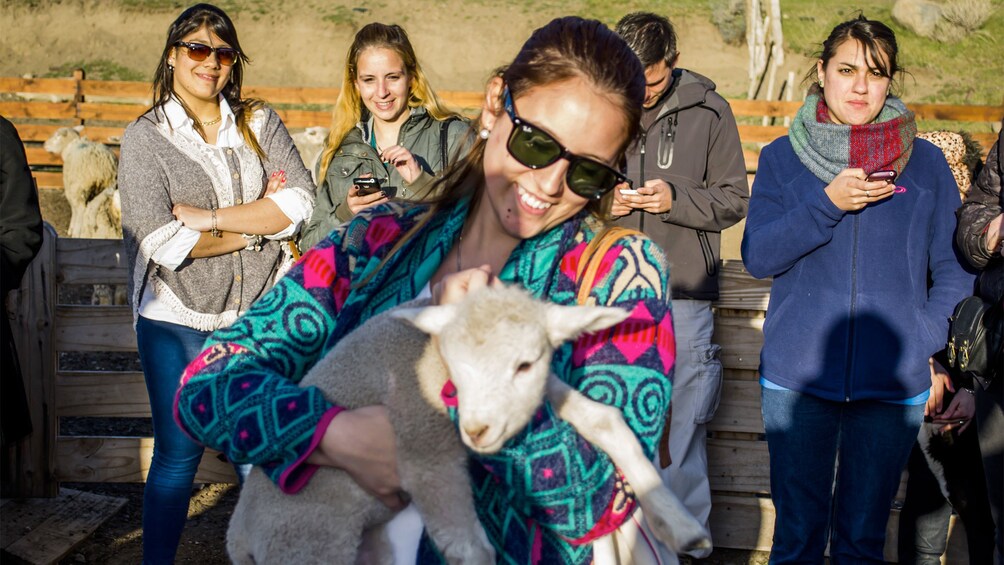 Woman holding a sheep on the 25 de Mayo Ranch Tour in Argentina
