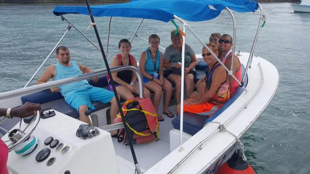 Show item 3 of 5. A boat full of people in the Bahamas