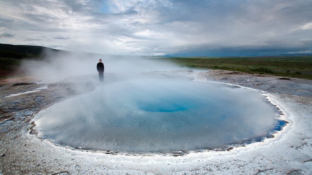Man stands next to GeoThermal pool